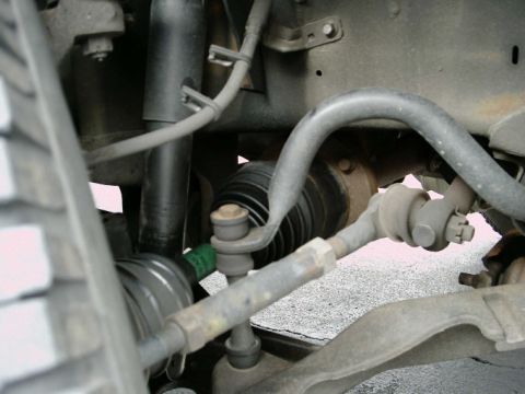 1997 Ford F-150 - Undercarriage view shows the tie rod end and CV joint boot of a vehicle's suspension system.