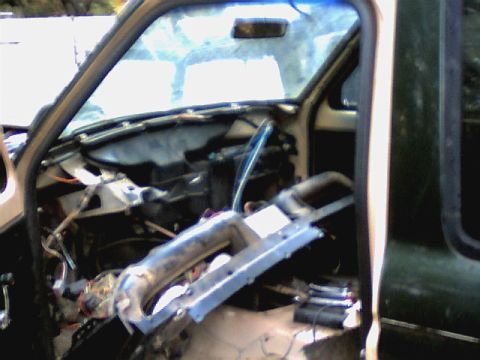 1987 Ford Bronco II - Interior of a vehicle with the dashboard removed, showing exposed wiring and components.