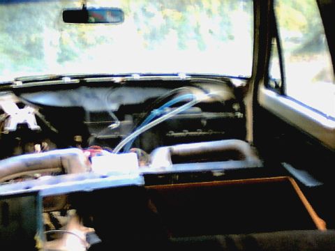 1987 Ford Bronco II - The interior of a vehicle is visible, with parts of the dashboard disassembled for work.