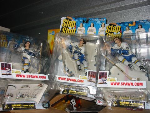 1991 Ford Bronco - Packaged action figures based on the movie Slap Shot are displayed on a shelf.