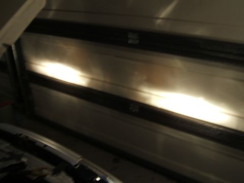 1998 Ford Taurus - Headlights of a car are visible, illuminating a textured garage door in the background.
