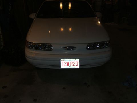 1998 Ford Taurus - Front view of a white 1998 Ford Taurus with its license plate visible.