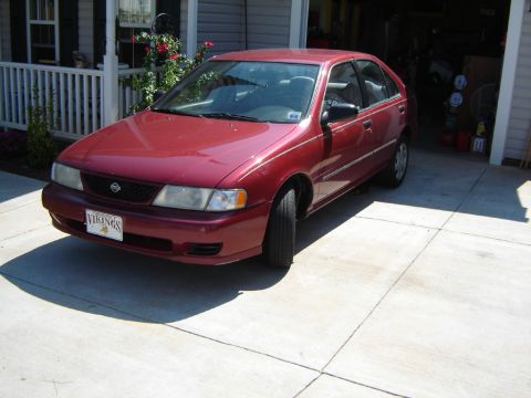 1998 Nissan Sentra - This 1998 Nissan Sentra is parked in front of a house and garage.