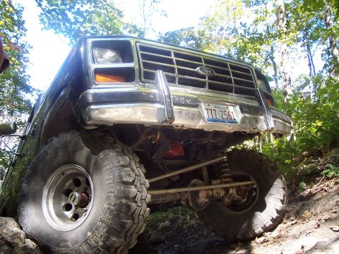 1986 Ford Bronco - This 1986 Ford Bronco is captured from a low angle while navigating rough terrain with its large off-road tires.