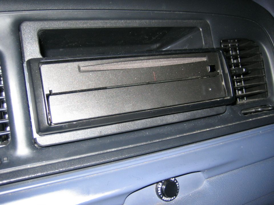 Dashboard close-up showing empty single-DIN radio slot with black faceplate between air vents