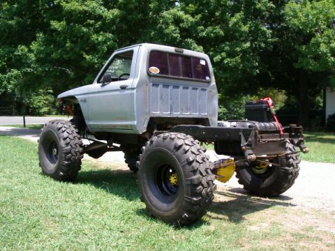 1985 Ford Bronco - This heavily modified truck chassis sits on massive off-road tires, ready for extreme terrain.