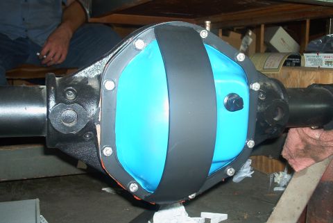 1983 Ford Bronco - Differential cover with blue fluid and black band, bolted to axle.