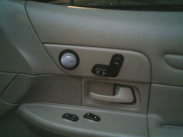 1999 Ford Crown Victoria interior door panel showing speaker grille and power seat controls