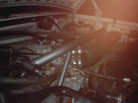 1978 Ford Bronco - The engine bay of a vehicle, showing a complex arrangement of hoses and mechanical parts.