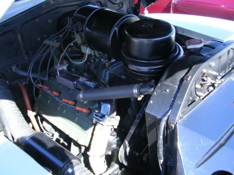 1996 Ford Probe - The engine bay of a classic car is shown, its V8 engine and air intake system.