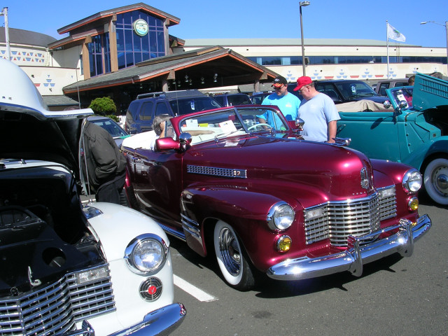 Maroon 1941 Cadillac convertible with chrome grille and whitewall tires