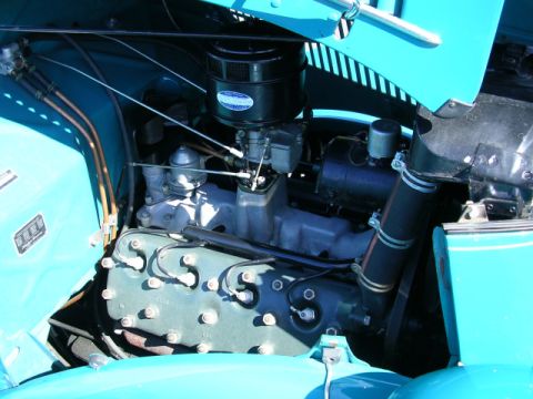1996 Ford Probe - The engine compartment of a vintage automobile is shown with its hood open.