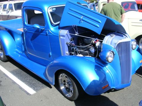 1996 Ford Probe - A bright blue pickup truck is displayed with its hood open, revealing the engine compartment.