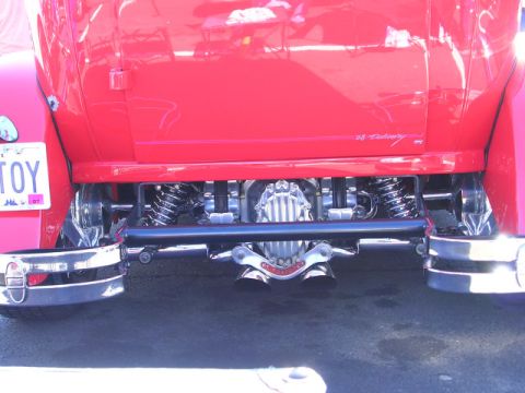 1996 Ford Probe - Close-up of a custom hot rod's rear axle, suspension, and dual exhaust system.