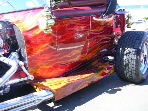 1996 Ford Probe - Custom hot rod features a vibrant flame paint job and exposed exhaust pipes.