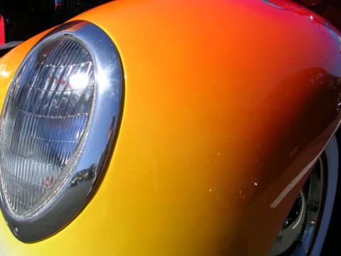 1996 Ford Probe - Detail of a custom hot rod's front end, showing a classic headlight and vibrant gradient paint.