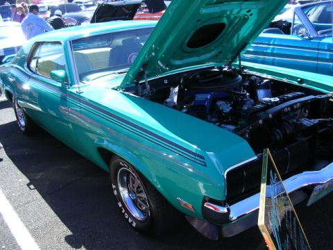 1996 Ford Probe - A teal 1970 Mercury Cougar is displayed with its hood open, revealing the engine compartment.