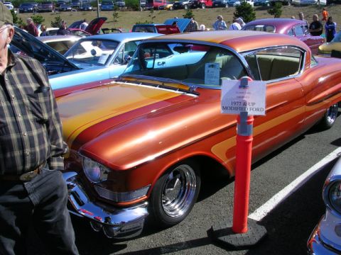 1996 Ford Probe - A customized coupe with a distinctive paint scheme is displayed at a car show.