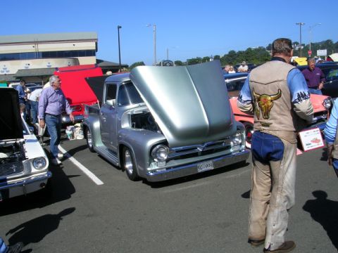 1996 Ford Probe - A classic 1956 Ford F-100 pickup truck is displayed with its hood open at a car show.