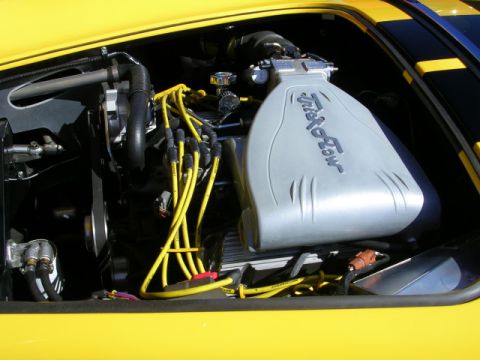1996 Ford Probe - Close-up view of a car's engine bay, highlighting the intake manifold and ignition system.