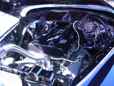 1996 Ford Probe - Customized engine bay a polished purple finish and chrome components, likely at a car show.