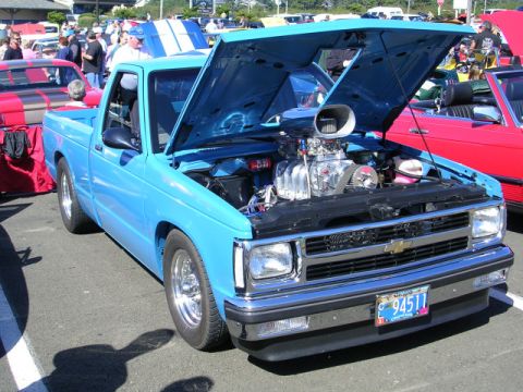 1996 Ford Probe - Custom blue pickup truck with a large supercharger on display at a car show.