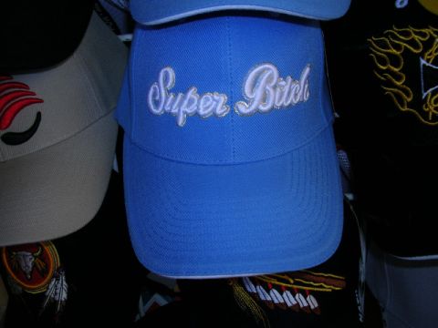 1996 Ford Probe - A blue baseball cap with embroidered text is displayed alongside other hats.