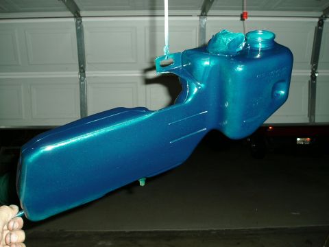 1993 Ford Taurus - A teal metallic painted part is shown hanging in a garage, likely after being refinished.