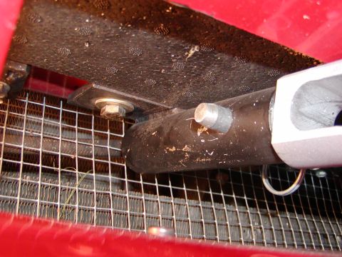 2003 Ford Mustang - Close-up view of the front grille and radiator support structure, showing a metal bar and bolt assembly.