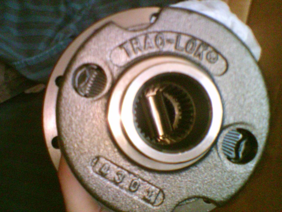 Hand holding Trac-Lok limited-slip differential carrier marked 10 3 0 4
