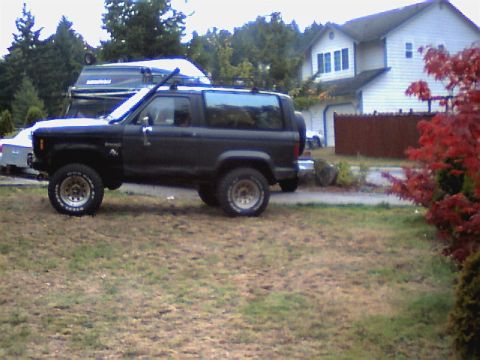 1987 Ford Bronco II - This 1987 Ford Bronco II features a lifted suspension and aggressive off-road tires, giving it a stance.