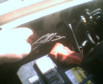 1989 Ford Bronco - Close-up view of frayed wires and a battery terminal, with a SuperMotors.net logo visible.
