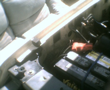 1989 Ford Bronco - Close-up view of a vehicle's engine bay, showing the battery and various electrical components. The Supermotors.com logo is present in the…