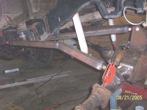 1994 Ford Bronco - Close-up view of custom rear suspension modifications, including a differential and shock absorbers, with a visible date stamp.