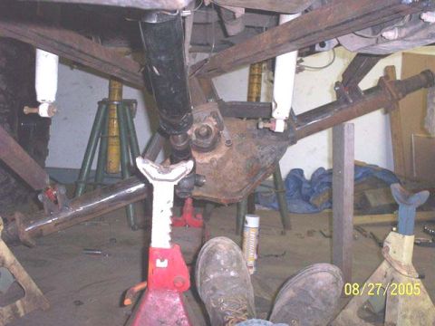 1994 Ford Bronco - Vehicle undercarriage with suspension components supported by jack stands, dated 08/27/2005.