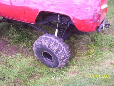 1994 Ford Bronco - The rear suspension and large tire of a red pickup truck are visible, with a date stamp of 09/04/2005.