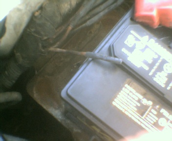 1989 Ford Bronco - Close-up of a car battery and associated wiring, with Supermotors.net branding.