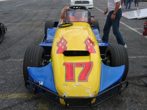 1985 Ford LTD Crown Victoria - This racing go-kart features a yellow hood with red flames and the number 17.
