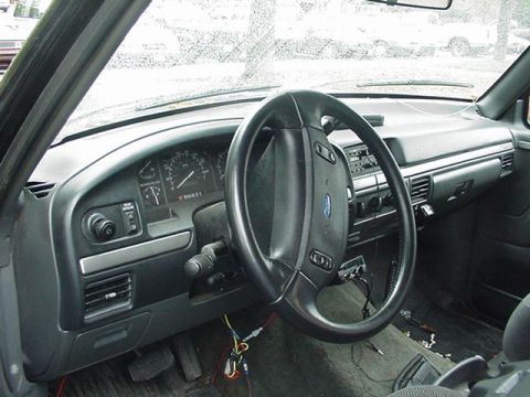 1993 Ford Bronco - Interior view of a 1993 Ford Bronco, highlighting the dashboard and steering wheel.