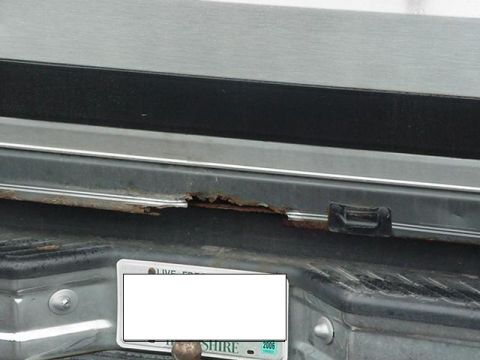 1993 Ford Bronco - Significant rust is visible on the lower edge of the tailgate and rear bumper area of this vehicle.