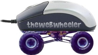 1990 Ford Bronco - novelty computer mouse shaped like a monster truck with oversized purple off-road wheels, branded 'thewebwheeler'.