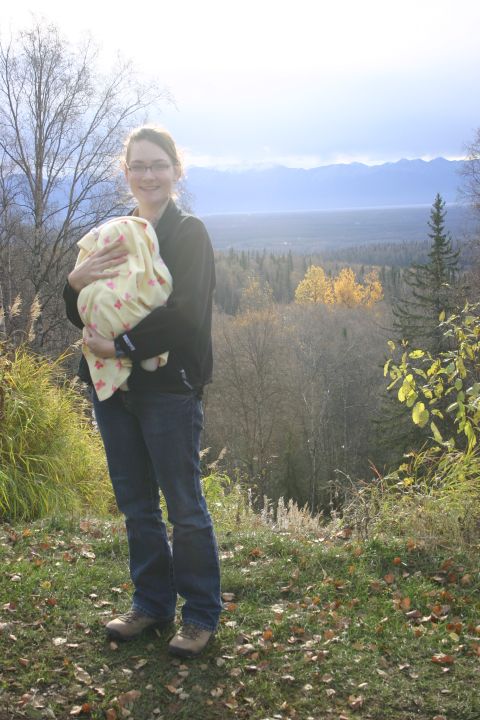 2003 Jeep TJ - Woman and baby pose for a photo with a scenic mountain and forest landscape in the background.
