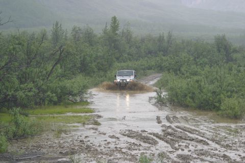 2003 Jeep TJ - Jeep TJ navigates a challenging muddy water obstacle on an off-road trail.