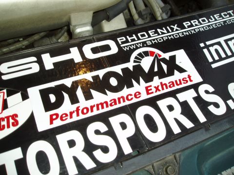 1993 Ford Taurus - Stickers for Dynomax Performance Exhaust and Phoenix Project are visible on a vehicle component.