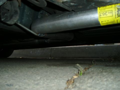 1993 Ford Taurus - Close-up of a vehicle's exhaust pipe, a yellow sticker with the part number '44 367'.