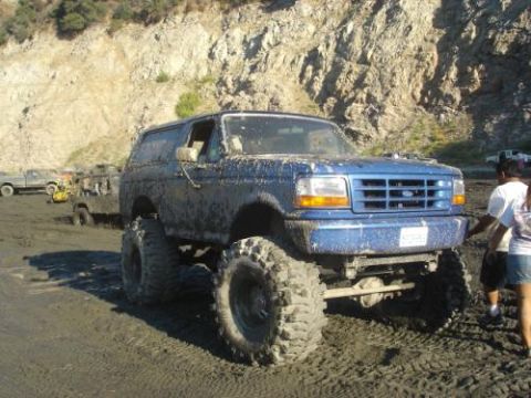 1991 Ford Bronco - This lifted 1991 Ford Bronco is caked in mud, suggesting it was used for off-roading.