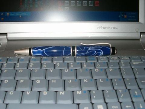 1995 Ford Bronco - A blue pen rests on a laptop keyboard, with the screen displaying a calendar and email application.