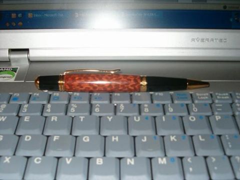 1995 Ford Bronco - A pen lies on a laptop keyboard, with a portion of the laptop screen visible in the background.