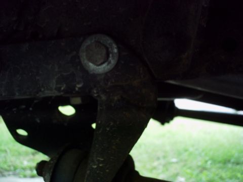 1986 Ford Bronco - Close-up view of a vehicle's undercarriage, focusing on a specific mechanical part.
