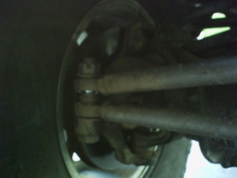 1986 Ford Bronco - Undercarriage view showing suspension and steering components near the tire.